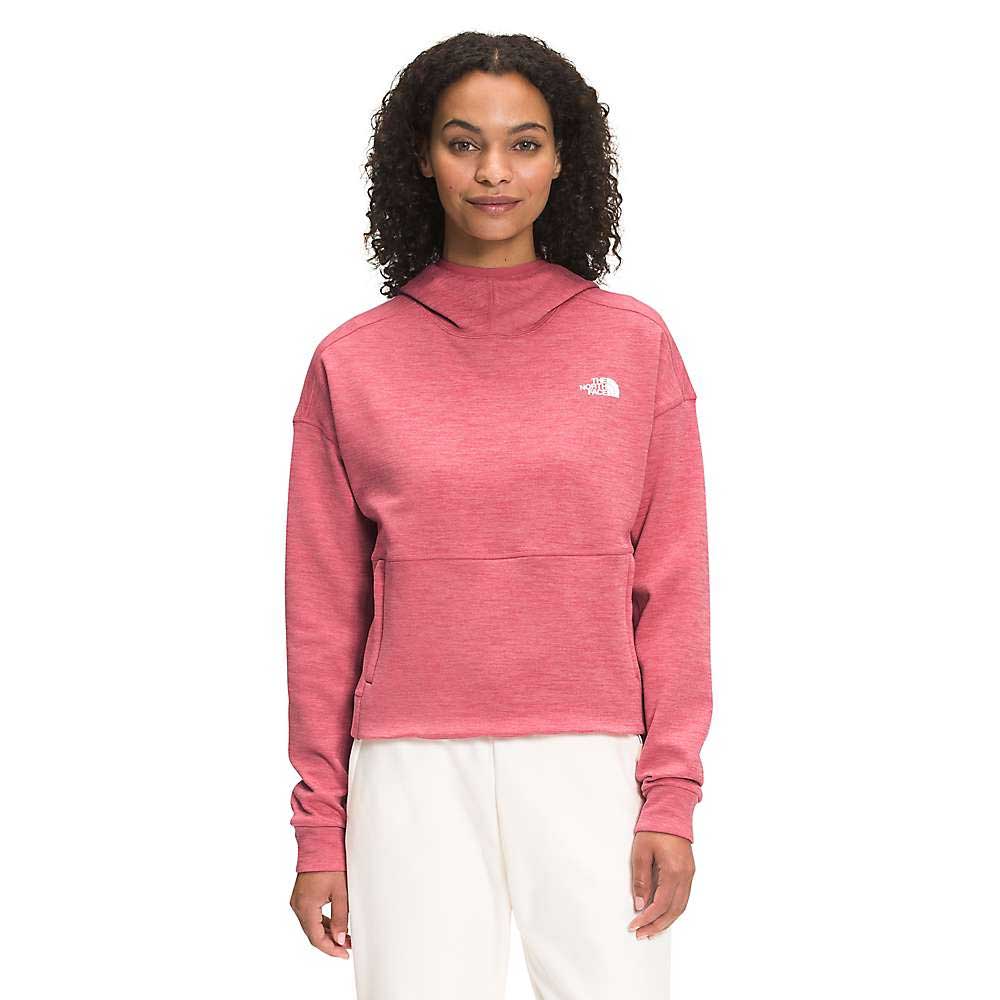 A woman with curly hair wears The North Face Womens Canyonlands Pullover Crop in pink and white pants, standing and facing forward against a plain white background.