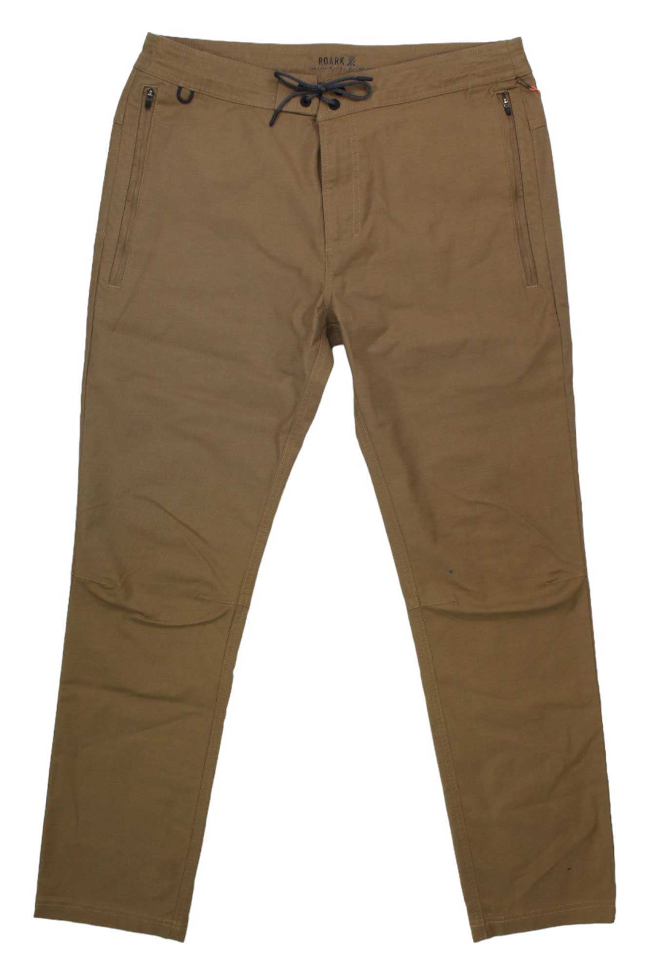 The Roark Men's The Layover 2.0 Pant in brown stretch canvas features a drawstring waist, two zippered front pockets, and a slim fit, shown laid flat on a white background.