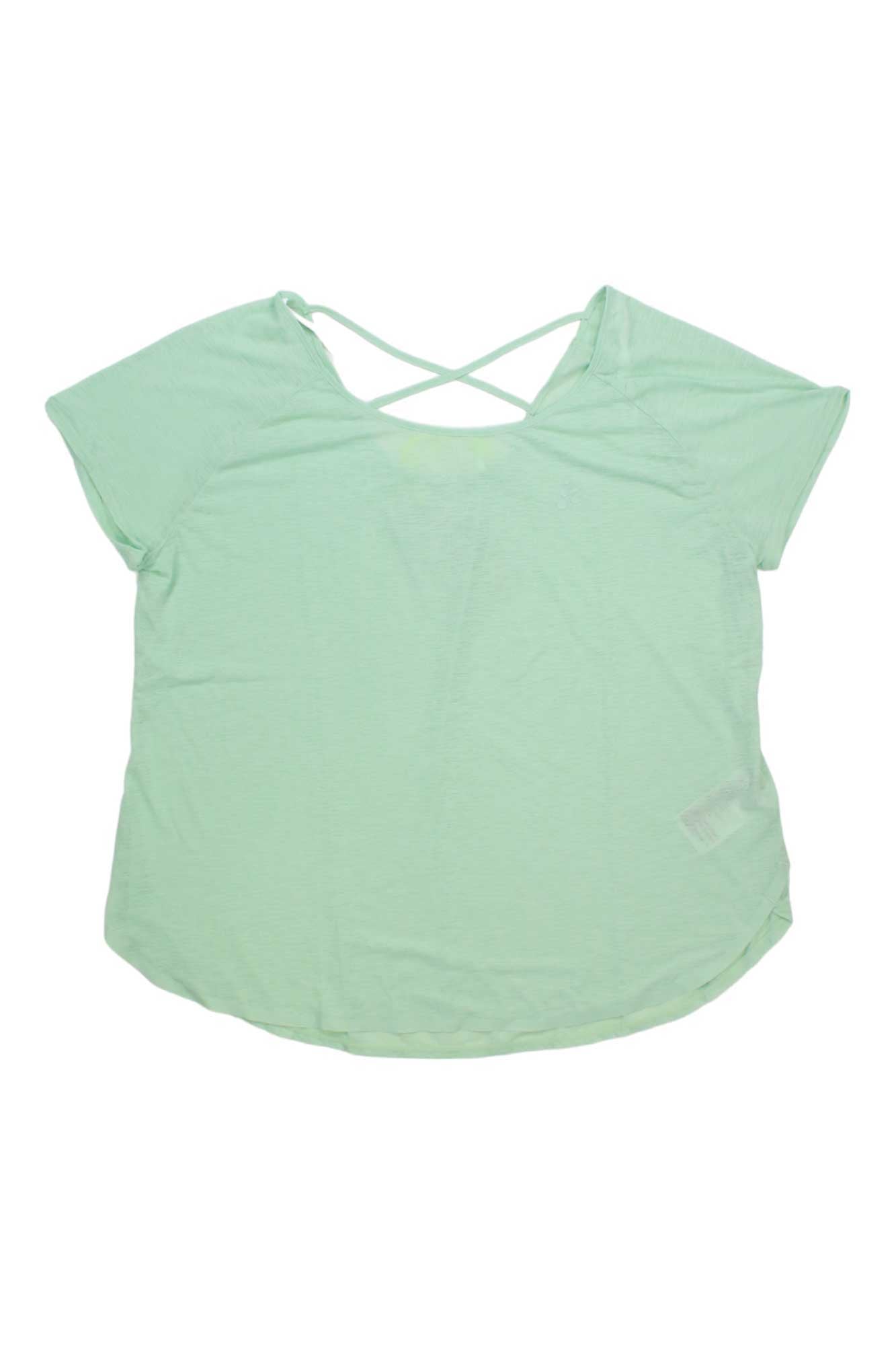 The Craft Sportswear Womens Core Charge Cross Back Tee is a light green, moisture-wicking gym top with a scoop neckline and crisscross back detail, shown laid flat on a white background—perfect for your next workout.