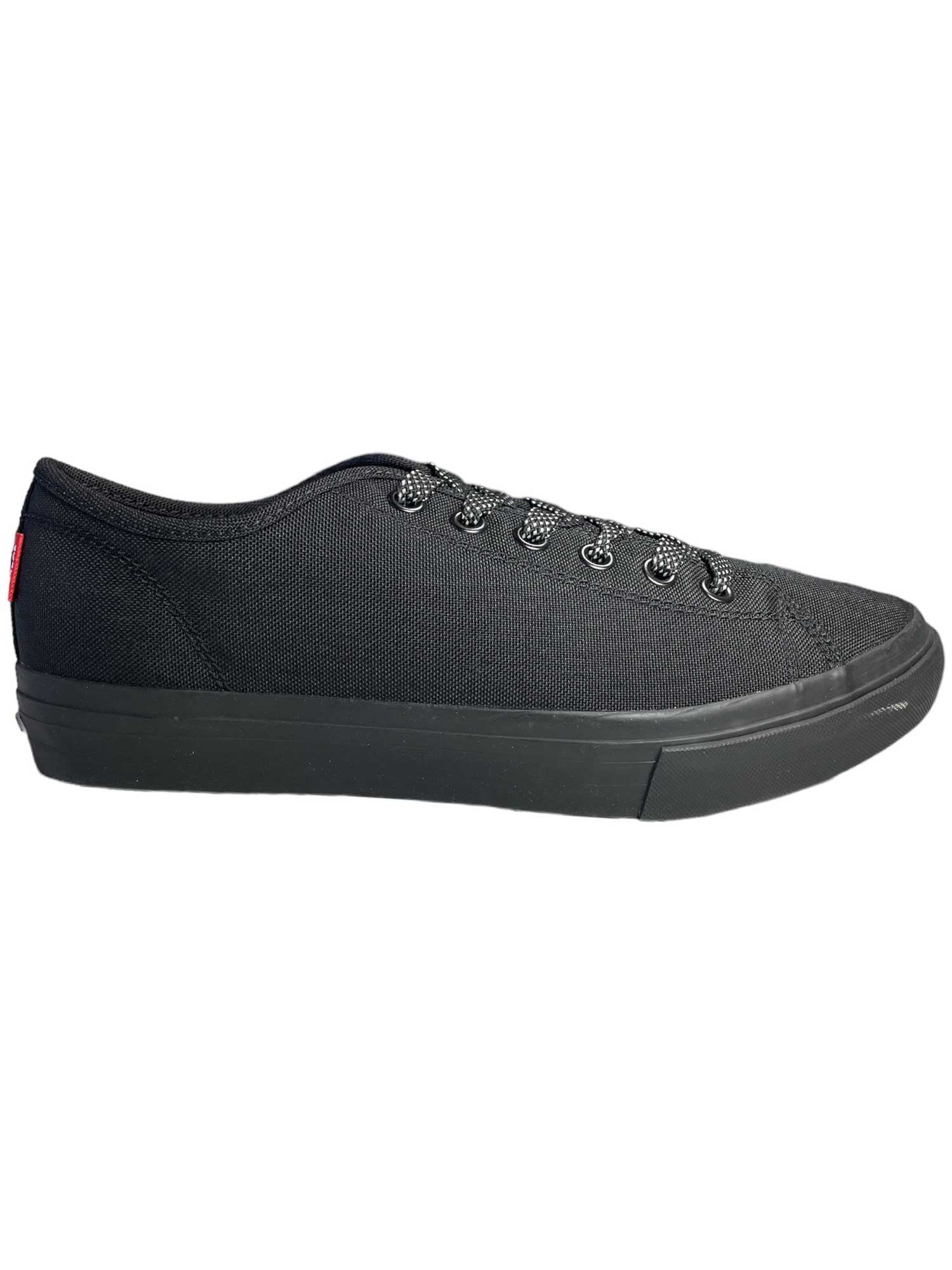 The Chrome Industries Men's Kursk AW Pro Shoe is a black canvas sneaker with black laces, a no-slip outsole, and a minimal design, inspired by cycling shoes and shown in a side profile on a white background.