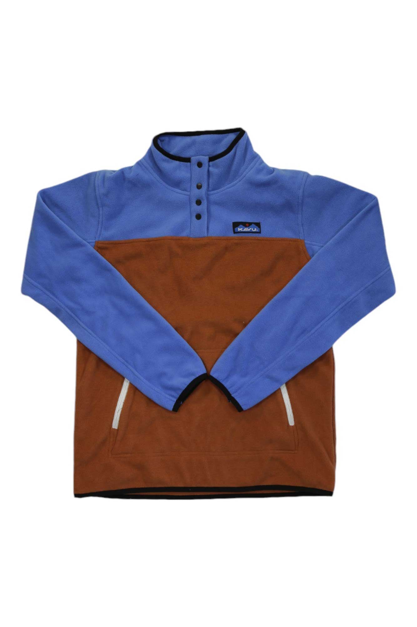 The KAVU Womens Cavanaugh Pullover is a polyester fleece with a blue upper, brown lower section, high collar with black buttons, zippered front pockets, and logo patch—ideal for travel.