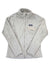 The Women's Full-Zip Re-Tool Jacket is a light gray Patagonia jacket made from Polartec Thermal Pro fleece, featuring a full front zip, long sleeves, a stand-up collar, and a left chest zip pocket.