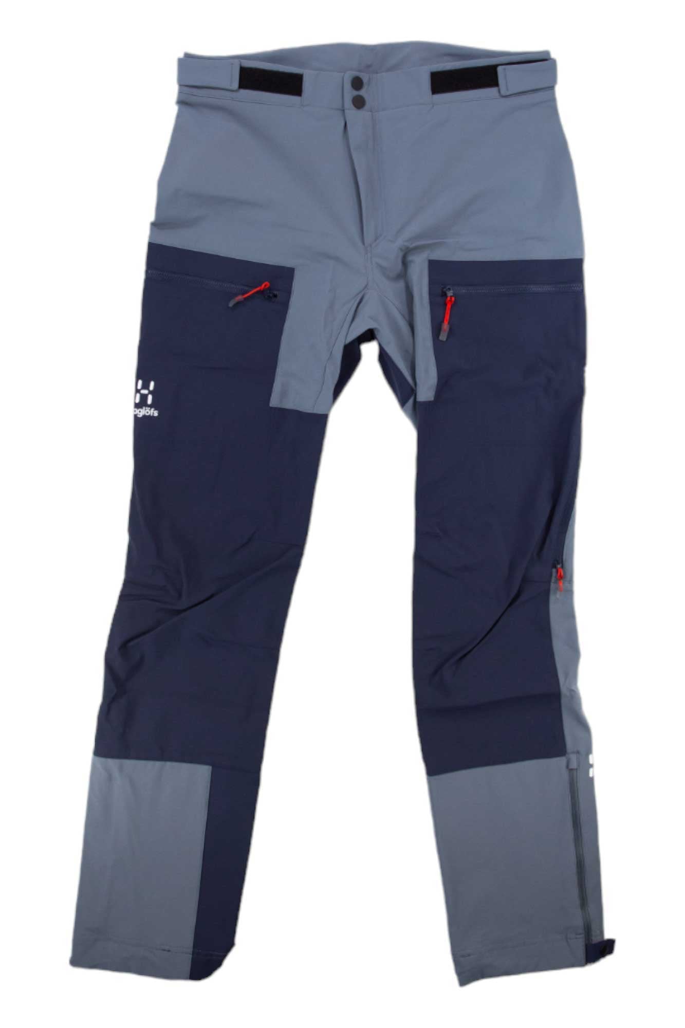 The Haglofs Womens Roc Sight Softshell Pant features gray and navy color-blocking, red zipper accents, reinforced knees and ankles, multiple pockets, and adjustable waist tabs—perfect for climbing or outdoor adventures.