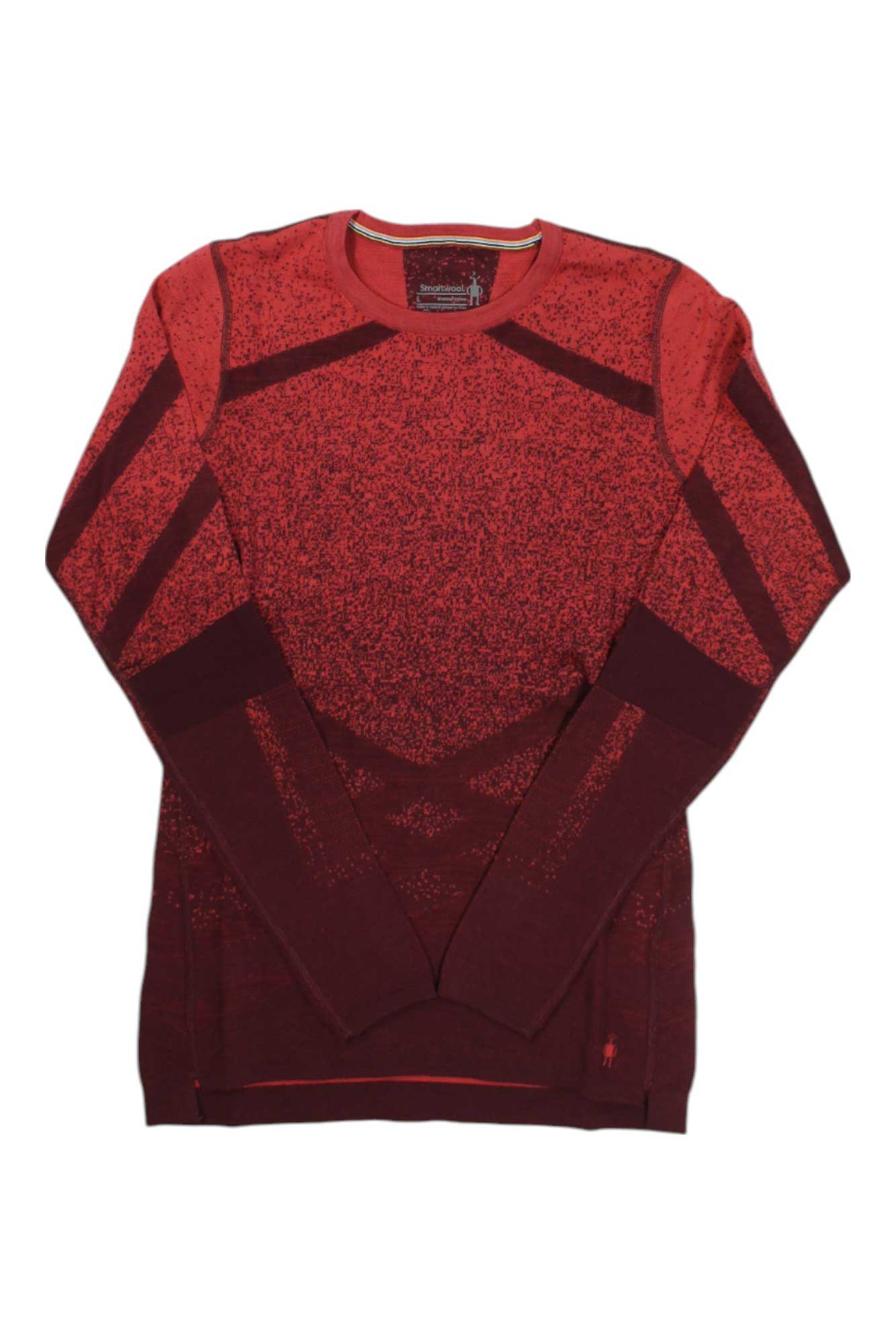 The Smartwool Women's Intraknit Thermal Merino Pattern Crew Base Layer Top, in red and maroon with geometric designs and a crew neckline, is shown laid flat on a white background.