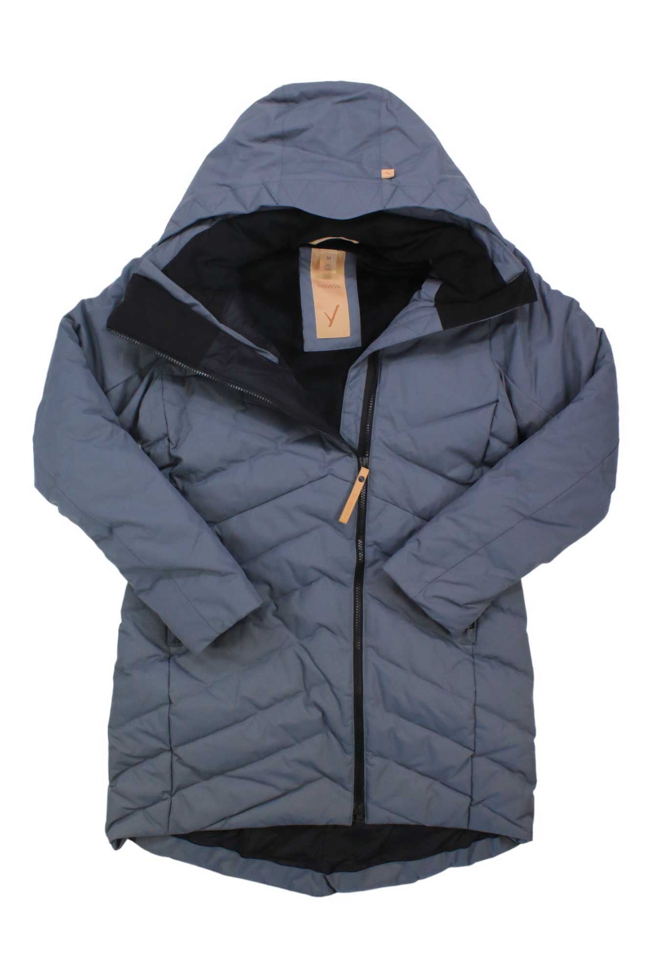 The Indyeva Womens Ayaba II Jacket is a gray, quilted, water-resistant coat featuring a hood, long sleeves, and an asymmetrical front zipper. It is shown lying flat on a white background.