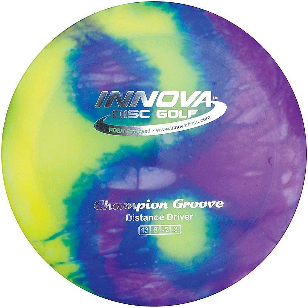 A vibrant Innova Disc I-Dye Driver featuring a swirl of yellow, green, purple, and blue. Text reads INNOVA Disc Golf, Champion Groove, Distance Driver. Flight ratings: 13 speed, 6 glide, -2 turn, 2 fade.