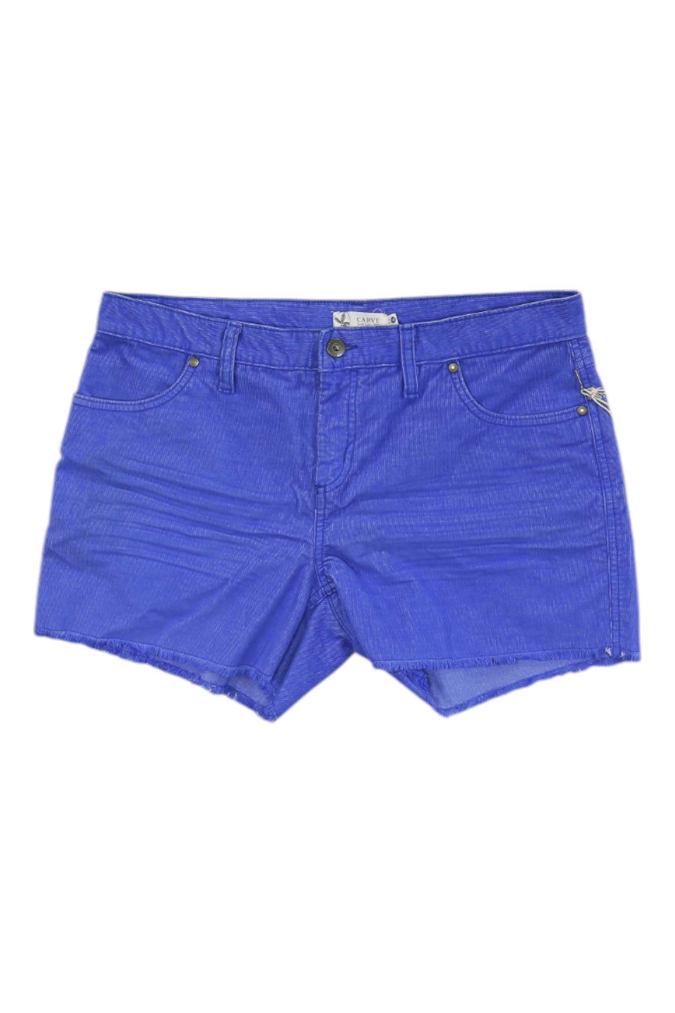 The Carve Designs Women's Oahu 4 Inch Short in bright blue features front and back pockets, belt loops, visible stitching, a slim fit, frayed hem, and metal rivets. Shorts are laid flat on a white background.