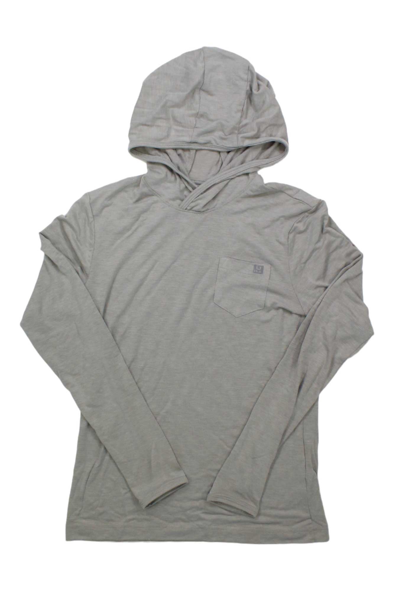 The Huk Womens Waypoint Hoodie, in light gray recycled polyester, features long sleeves, a hood, and a small chest pocket, shown laid flat on a white background.