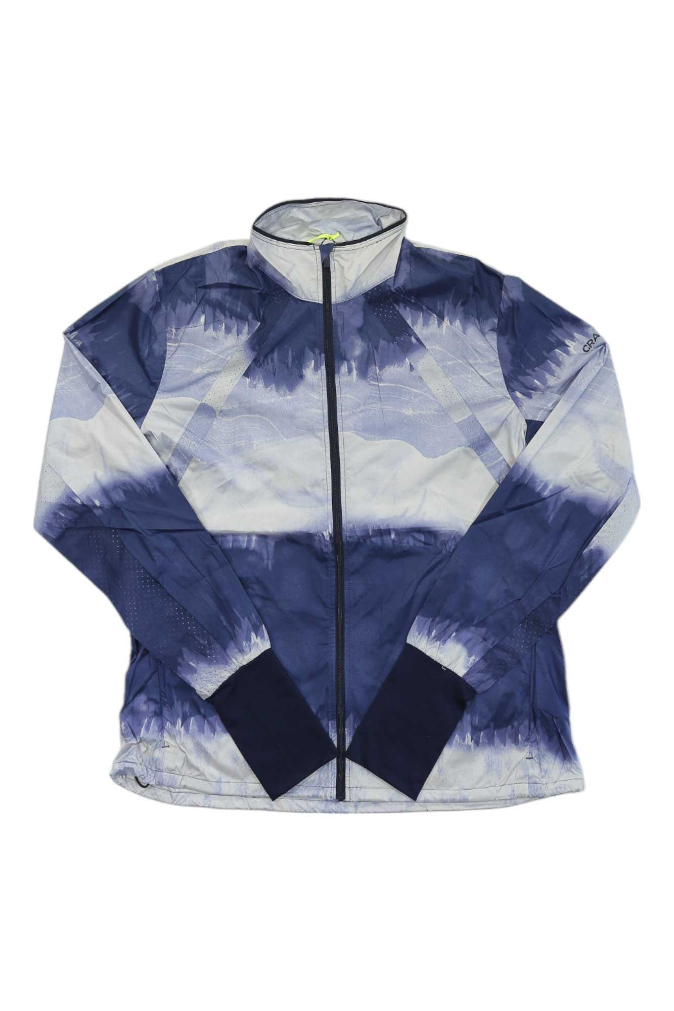 The Craft Sportswear Womens Adv Essence Wind Jacket is a blue and white tie-dye running jacket with navy cuffs, zipper closure, and made from recycled polyester.