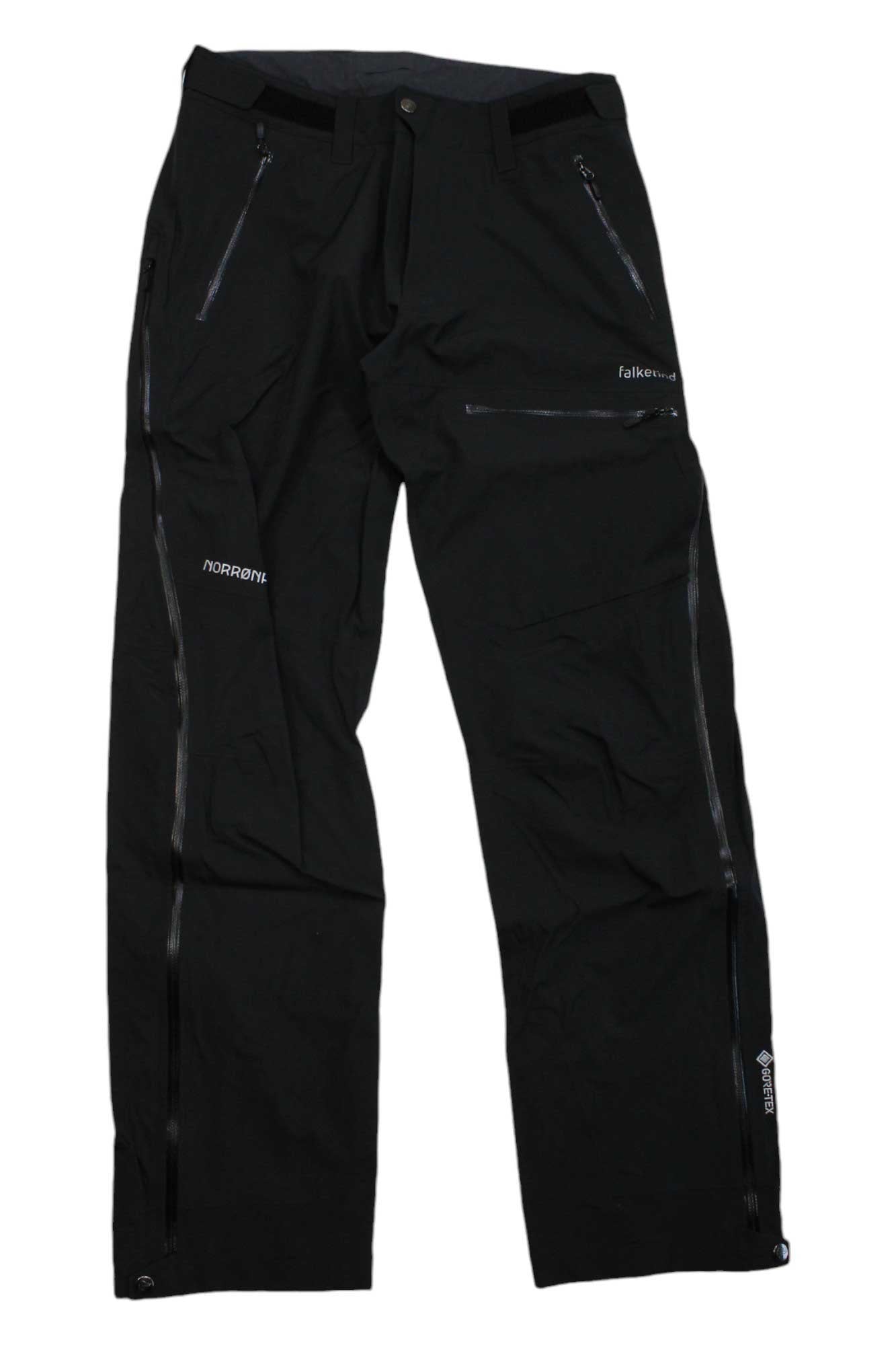 The Norrona Mens Falketind GTX Pant is a pair of black outdoor pants with zippered pockets and ventilation, featuring Norrøna and Falketind logos. Waterproof and breathable, these pants offer comfort and durability for any adventure.