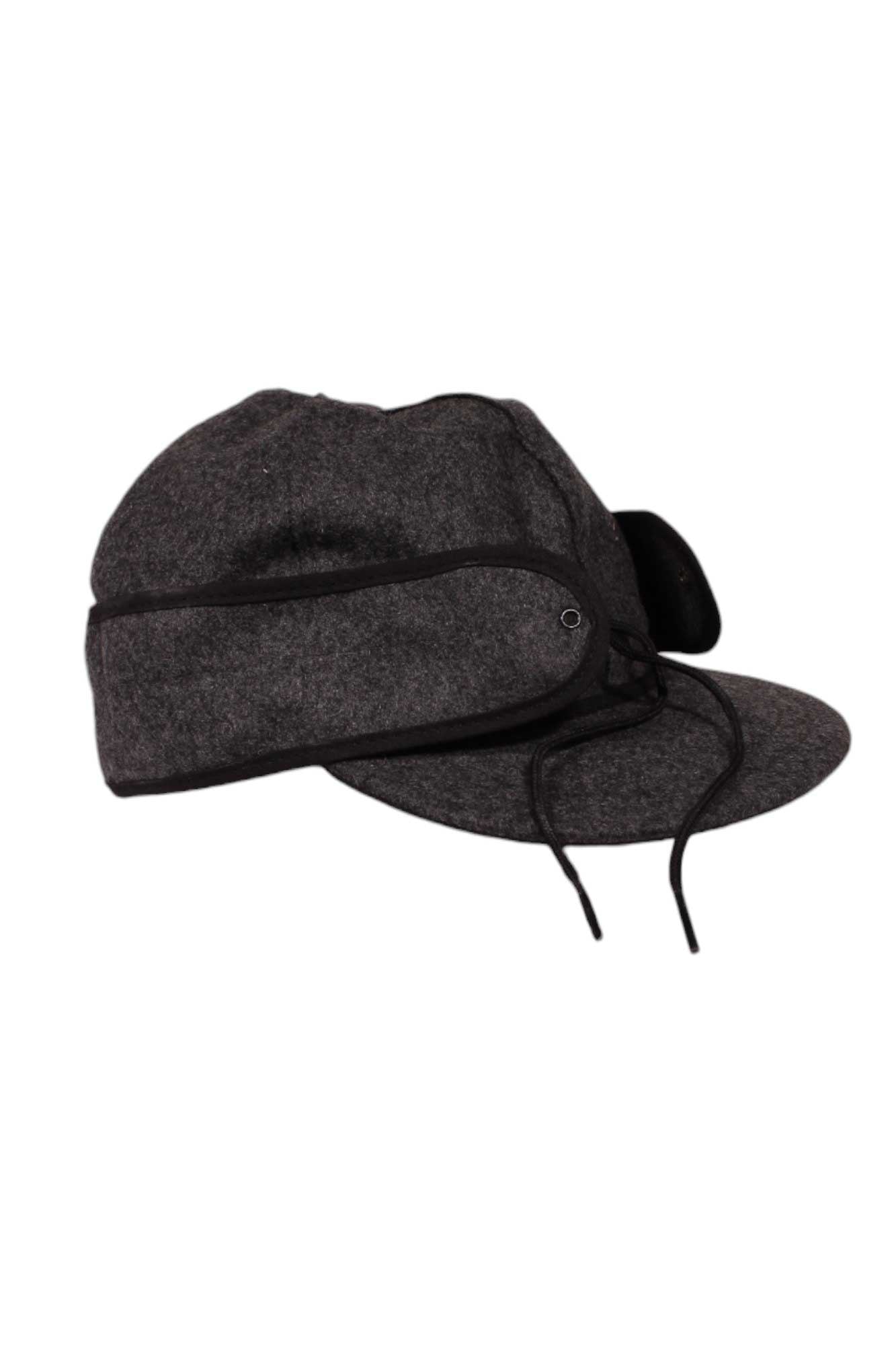 The Stormy Kromer Original Cap is a dark gray wool hat with black trim, front strings to secure fold-down ear flaps, and is shown against a white background.
