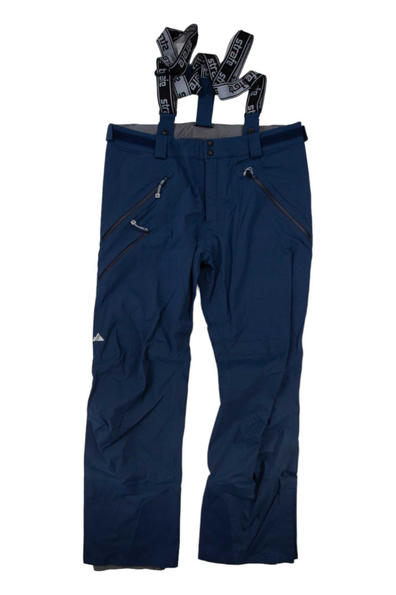 Strafe Mens Capitol Pant in navy blue, featuring black and white adjustable suspenders, zippered side pockets, and a logo on the left thigh. These waterproof ski pants are displayed flat on a white background.
