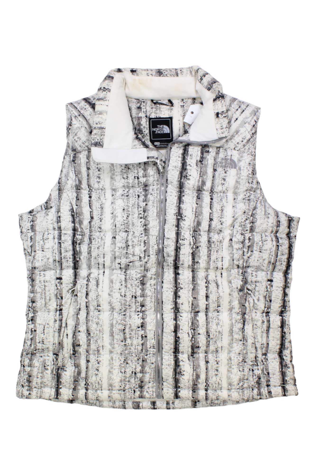 The Womens Nuptse 2 Down Vest is a sleeveless, zip-up vest with a black and white striped textured pattern, stand-up collar, visible inner tag featuring The North Face logo, and insulated with 700-fill-power goose down for warmth.