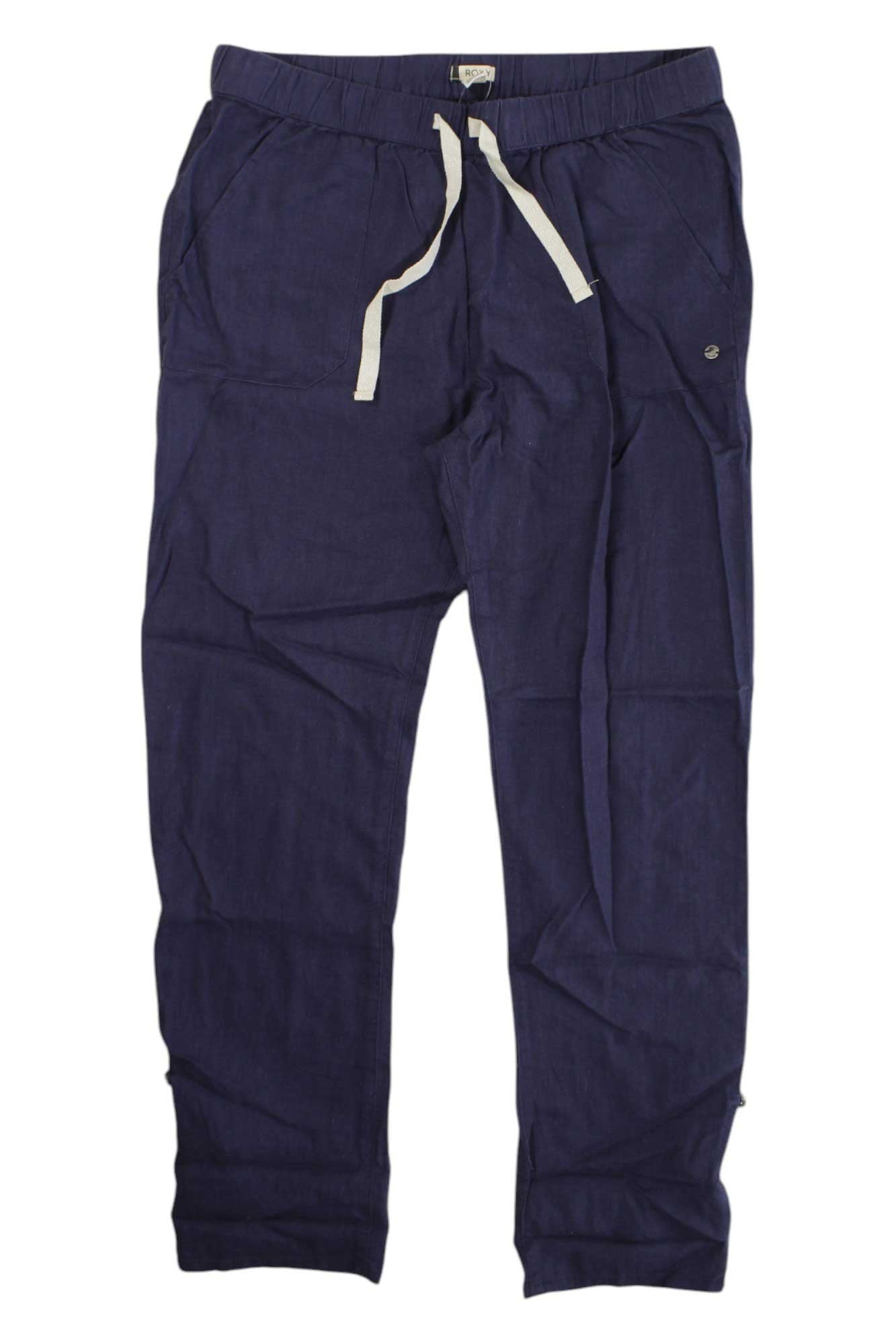 A pair of Roxy Womens On The Seashore Pant in navy blue, featuring a relaxed fit, white drawstring laces, elastic waistband, and side pockets, laid flat on a white background.