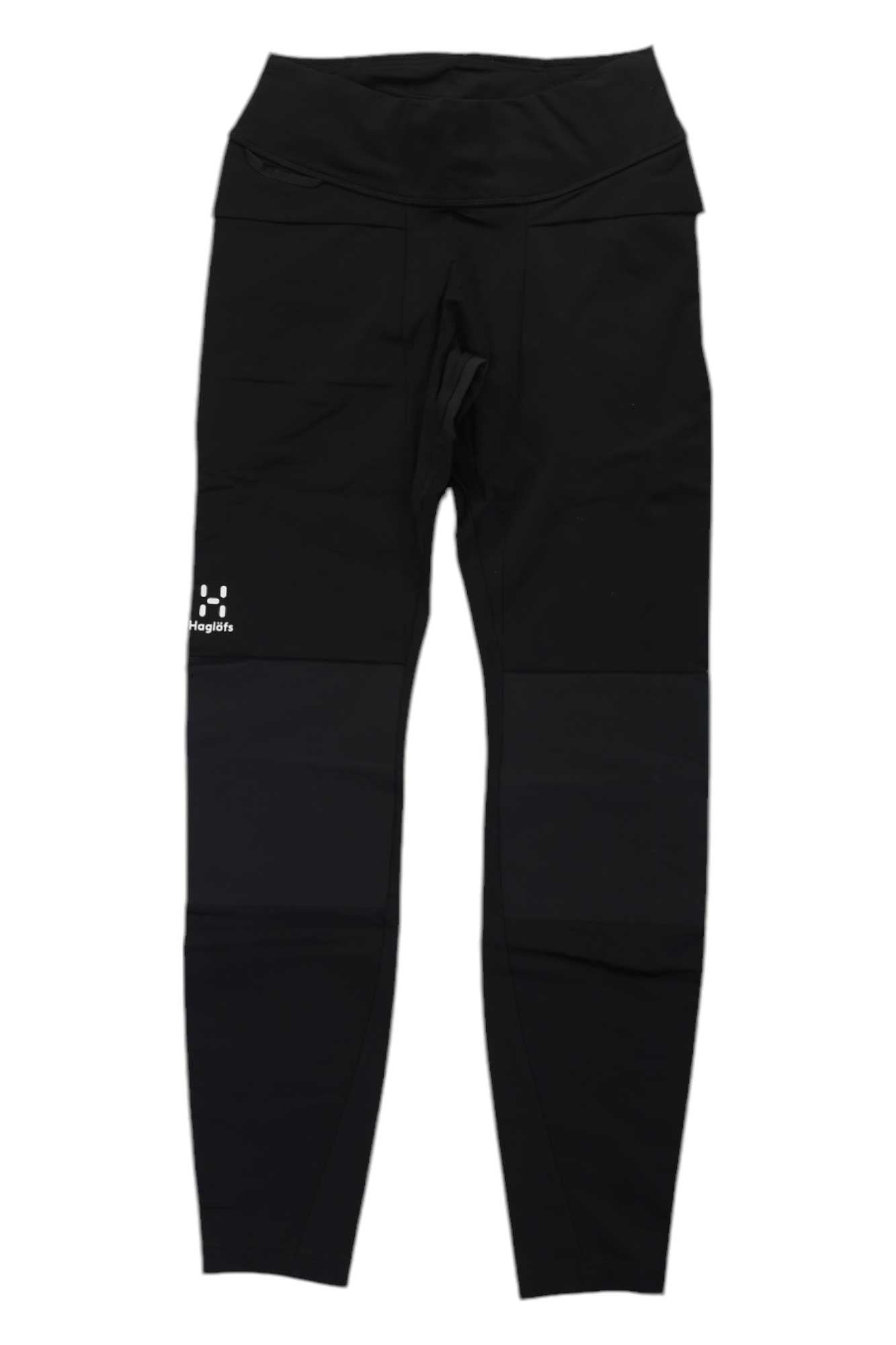 The Haglofs Womens Luna Tight are black athletic leggings made from recycled polyamide, featuring a high waist and a small white Haglöfs logo on the left thigh. These plain women's hiking tights have no visible patterns or decorations.