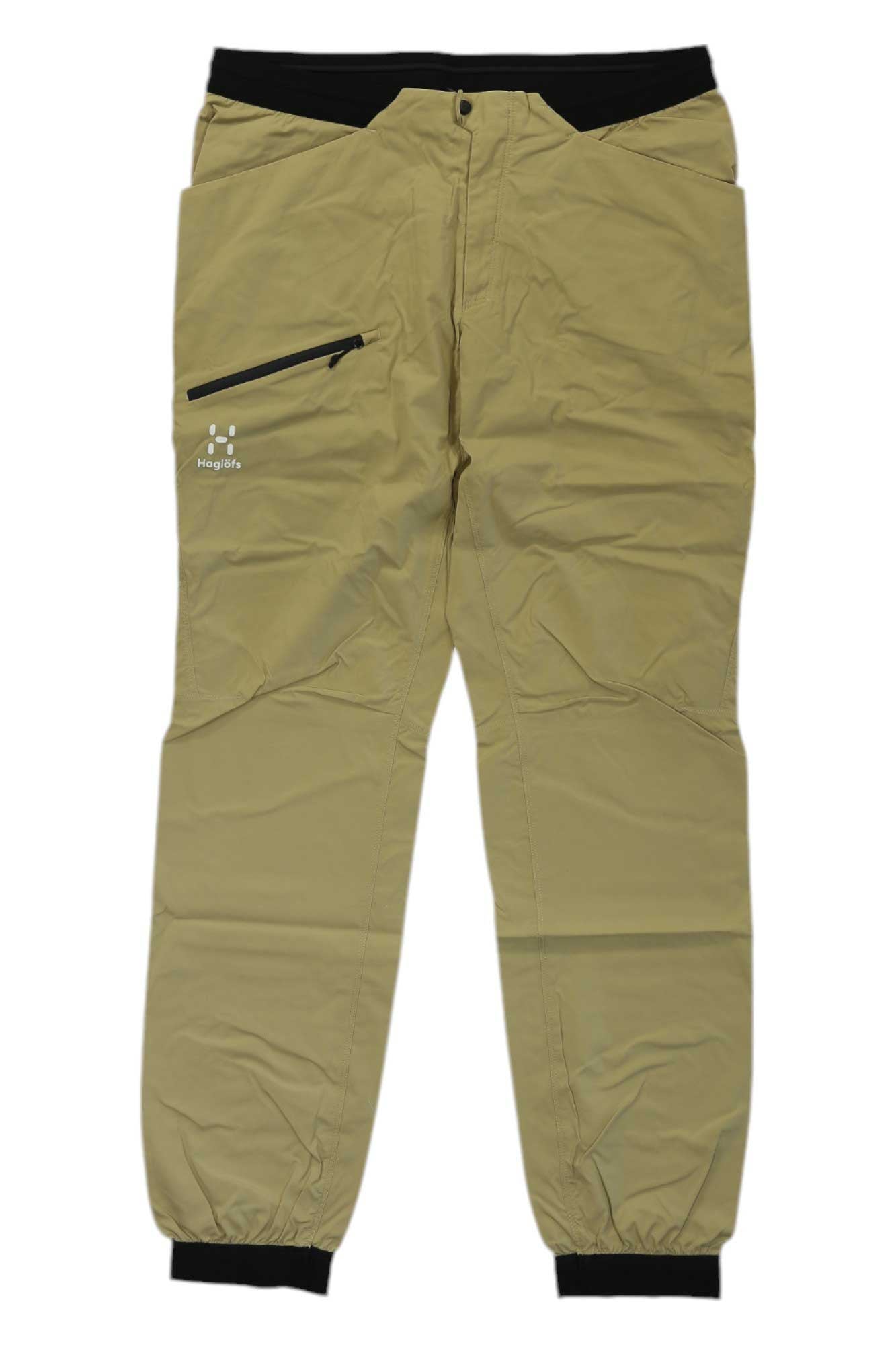 The khaki Haglofs Womens L.I.M Fuse Pant has a black waistband and cuffs, a left thigh zippered pocket, and a lightweight, breathable design—perfect outdoor pants for women who need comfortable hiking gear.