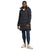 A woman stands facing forward against a white background, wearing a long black The North Face Womens Metropolis Parka, blue cuffed pants, white sneakers, and a white shirt.