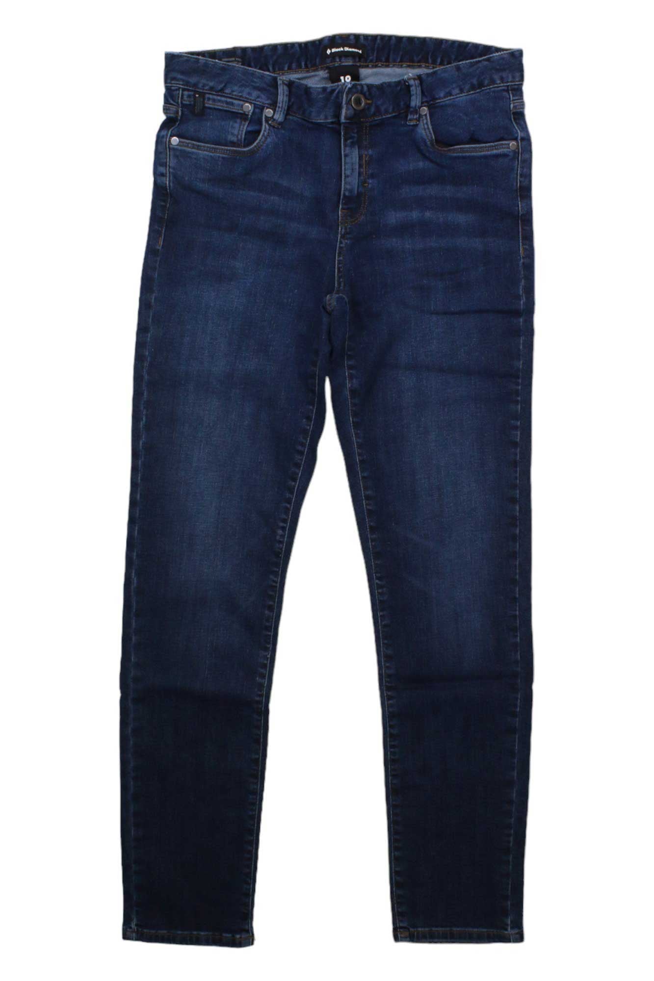 The Black Diamond Womens Crag Denim Pant is a pair of dark blue, straight-leg jeans with front and back pockets, button and zipper closure, and harness compatibility for comfortable climbing, shown laid flat on a white background.