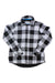 The Womens Fleeced Lined Flannel Pinnacle Shirt Jacket features a long-sleeve, button-up design in a classic black and white buffalo check plaid, displayed flat with sleeves crossed at the wrists.