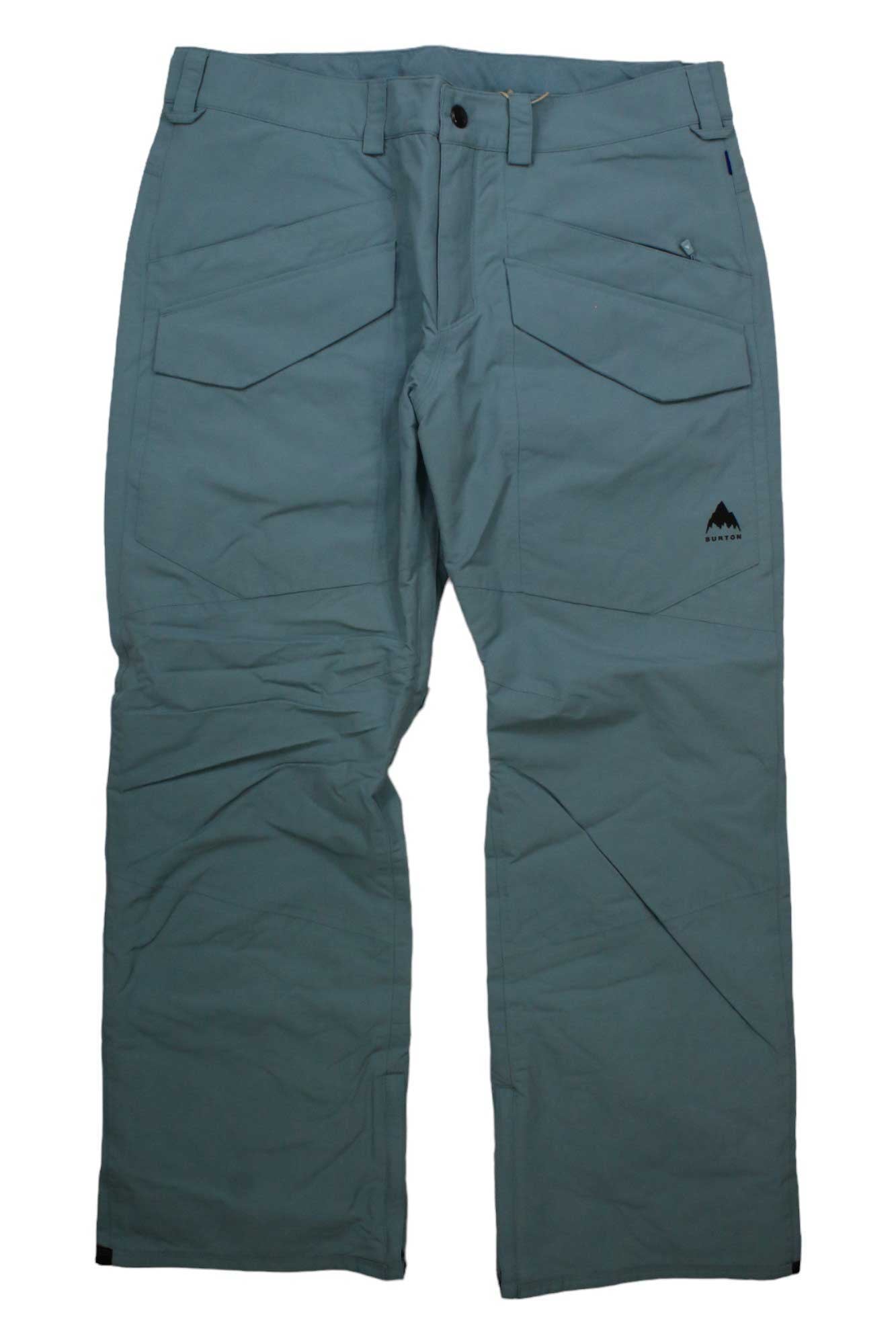 The Burton Mens Covert 2.0 Insulated Pant in light blue-green features two large front cargo pockets, a small zippered pocket, a black mountain logo on the right thigh, and a button-zip closure—ideal outdoor pants for hiking.
