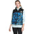 A person wears a light blue hoodie under The North Face Women's 1996 Retro Nuptse Vest in blue camo with black top, 700-fill goose down, and logo, standing against a plain white background.
