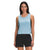 A woman with long dark hair wears The North Face Womens Wander Crossback Tank in light blue and black shorts, standing and smiling slightly against a plain white background.