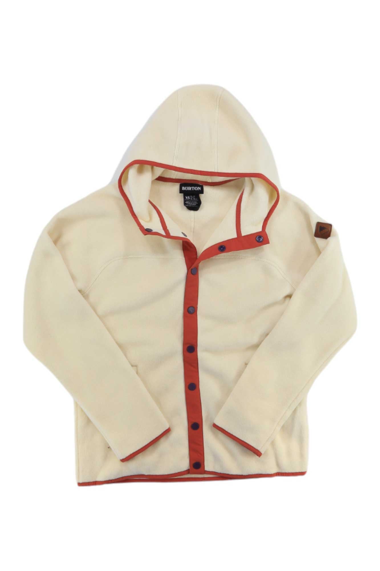 The cream Burton Women's Hearth Snap Jacket features Polartec fleece, red trim, black buttons, a left sleeve patch, visible Burton branding inside the collar, and is bluesign approved.