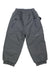 The Obermeyer Kids Campbell Pant is a pair of dark grey, insulated ski pants with elastic cuffs and waistband, two zippered front pockets, and the Obermeyer logo on the left leg.