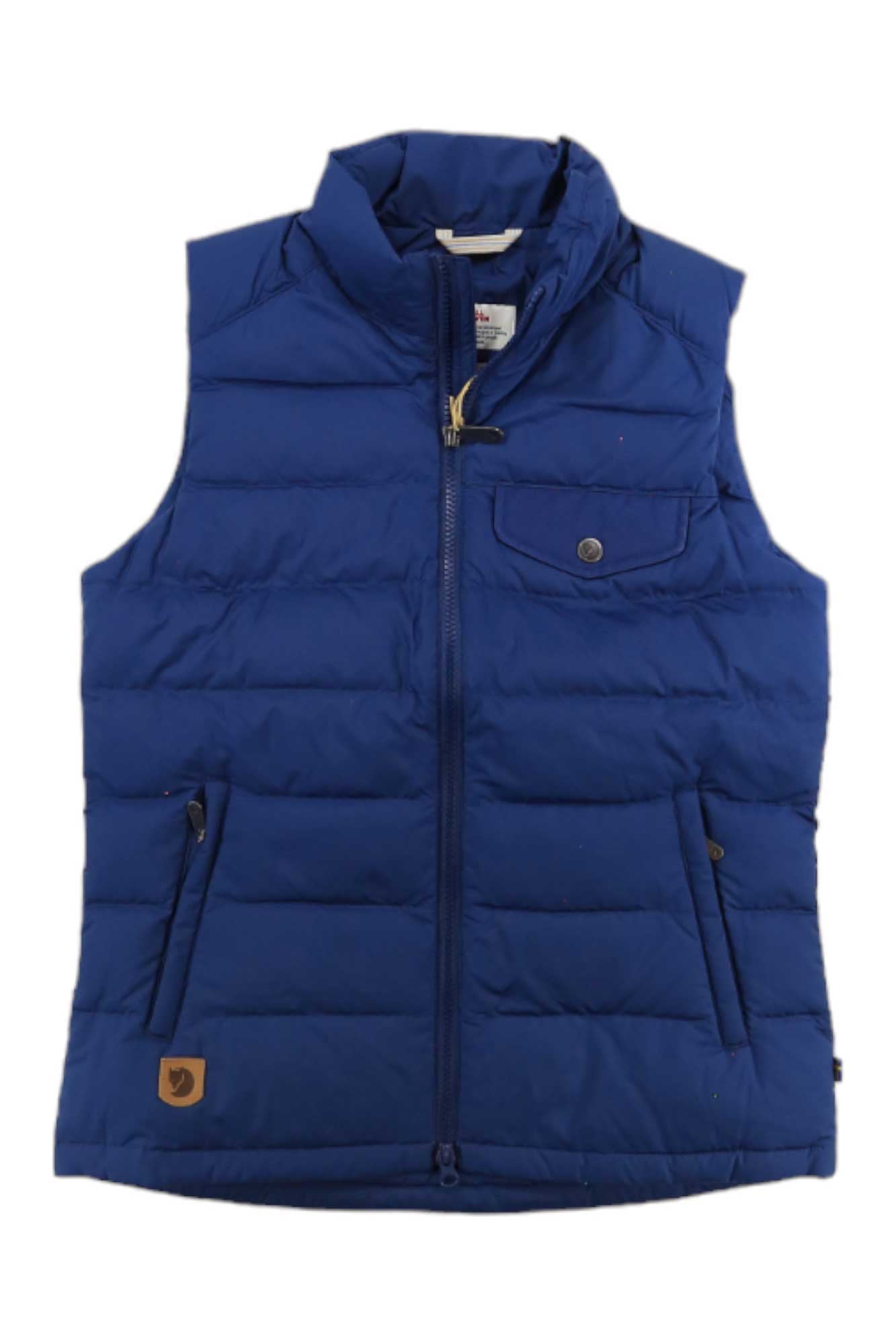 The Greenland Down Liner Vest is a sleeveless, quilted blue vest made from recycled polyester, featuring a front zipper, snap-button chest pocket, side pockets, and a brown logo patch by the hem.