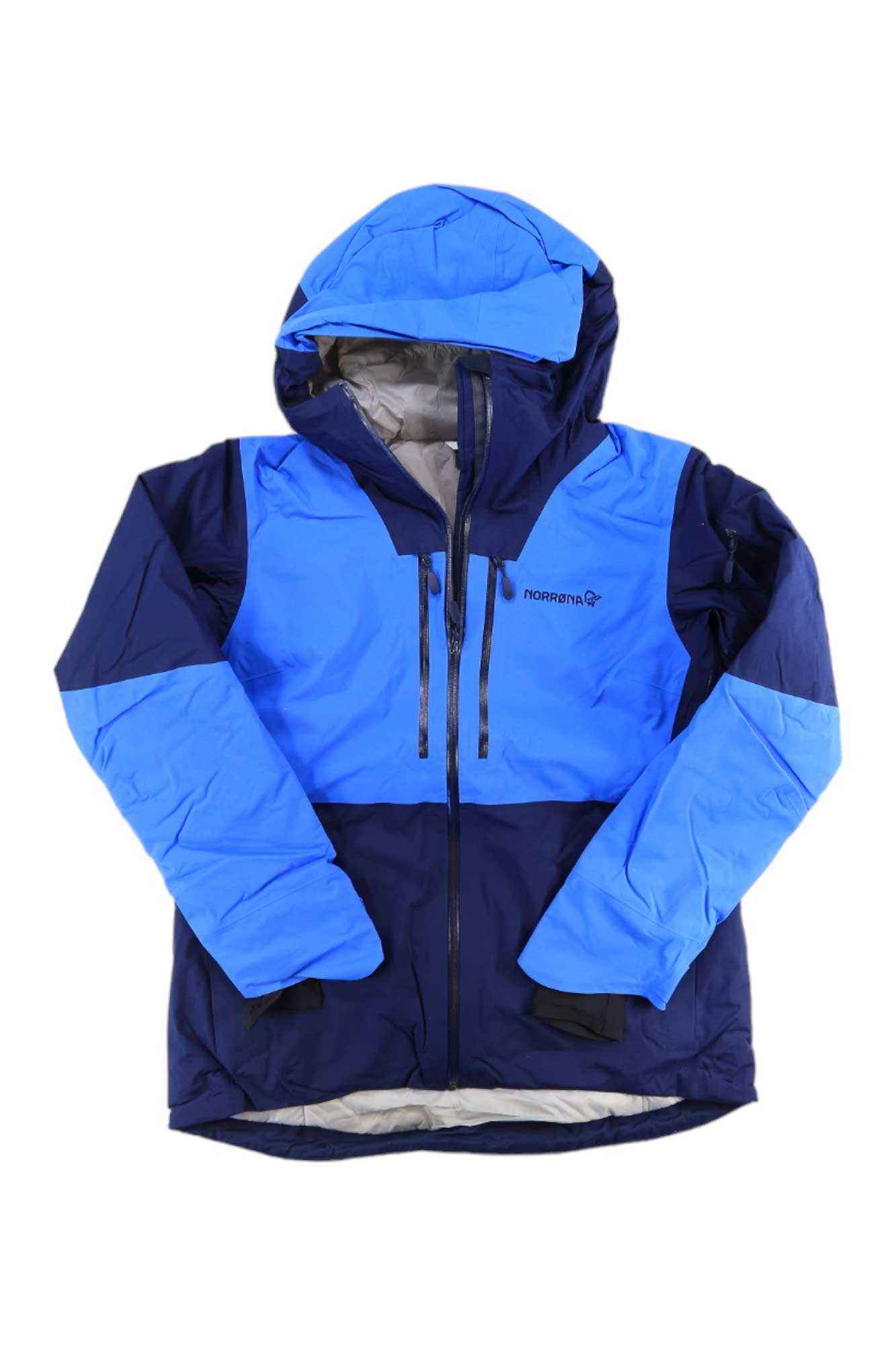 The Norrona Womens Lofoten GTX Thermo100 Jacket is a blue and navy insulated ski jacket with GORE-TEX waterproof fabric, front zipper, two chest zip pockets, and the Norrona logo on the front left side.