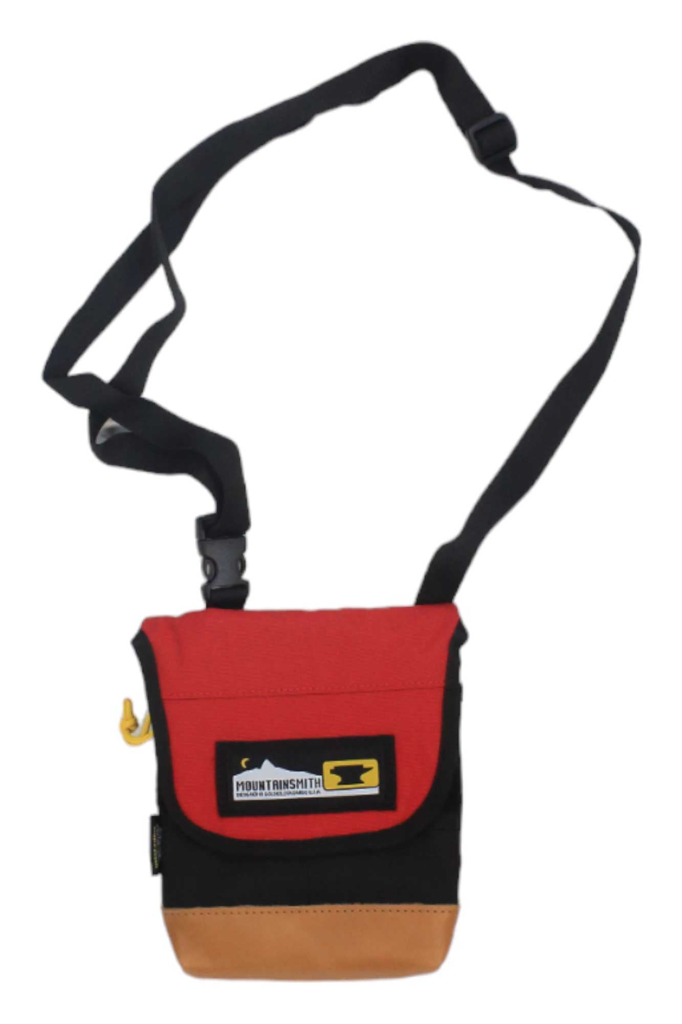 The Mountainsmith Trippin Pouch Waistpack is a small crossbody pouch with a black strap, red flap featuring a mountain patch and text, black body, tan base, and yellow zipper pull on the side.