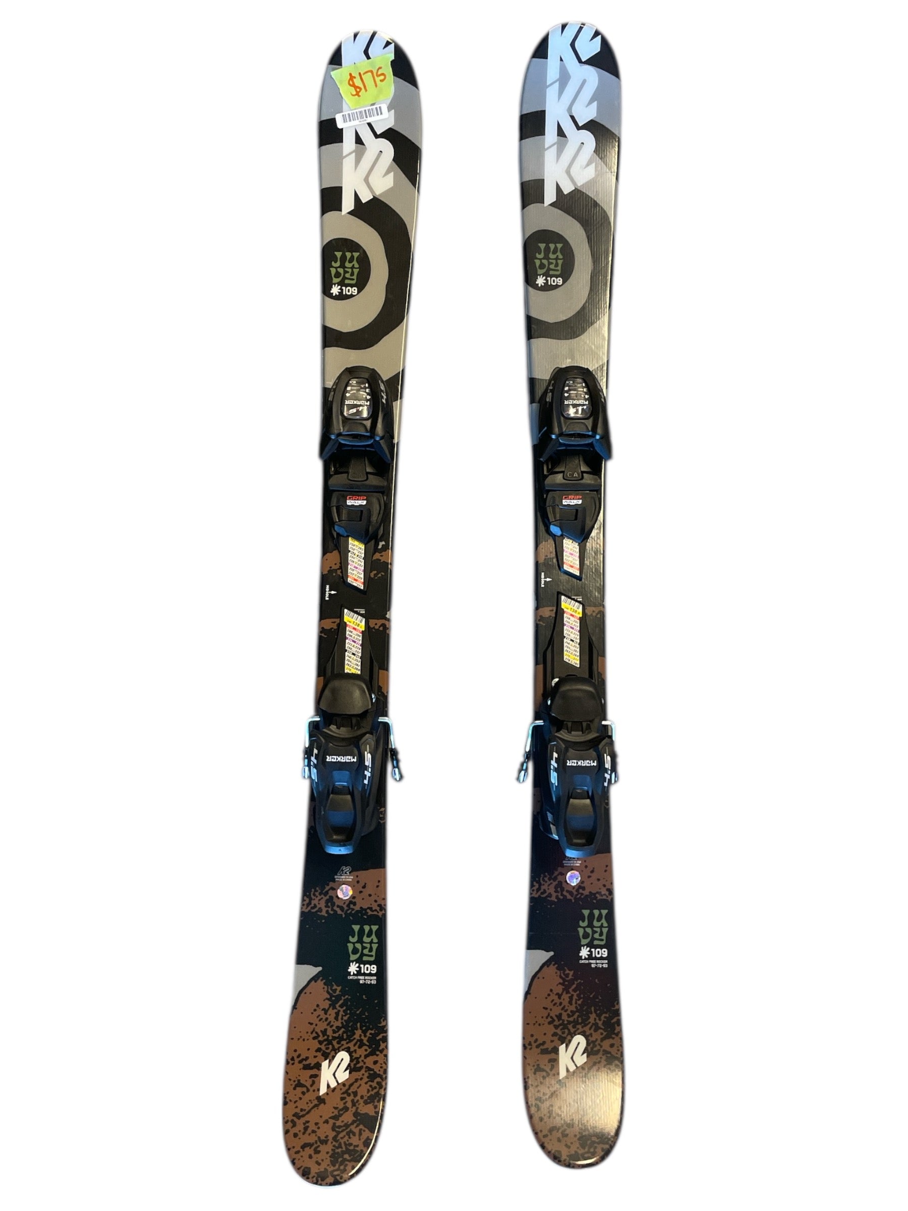 A pair of K2 Juvy Skis with FDT 4.5 Bindings for beginners, featuring a black, gray, and brown abstract design, are displayed side by side on a white background.