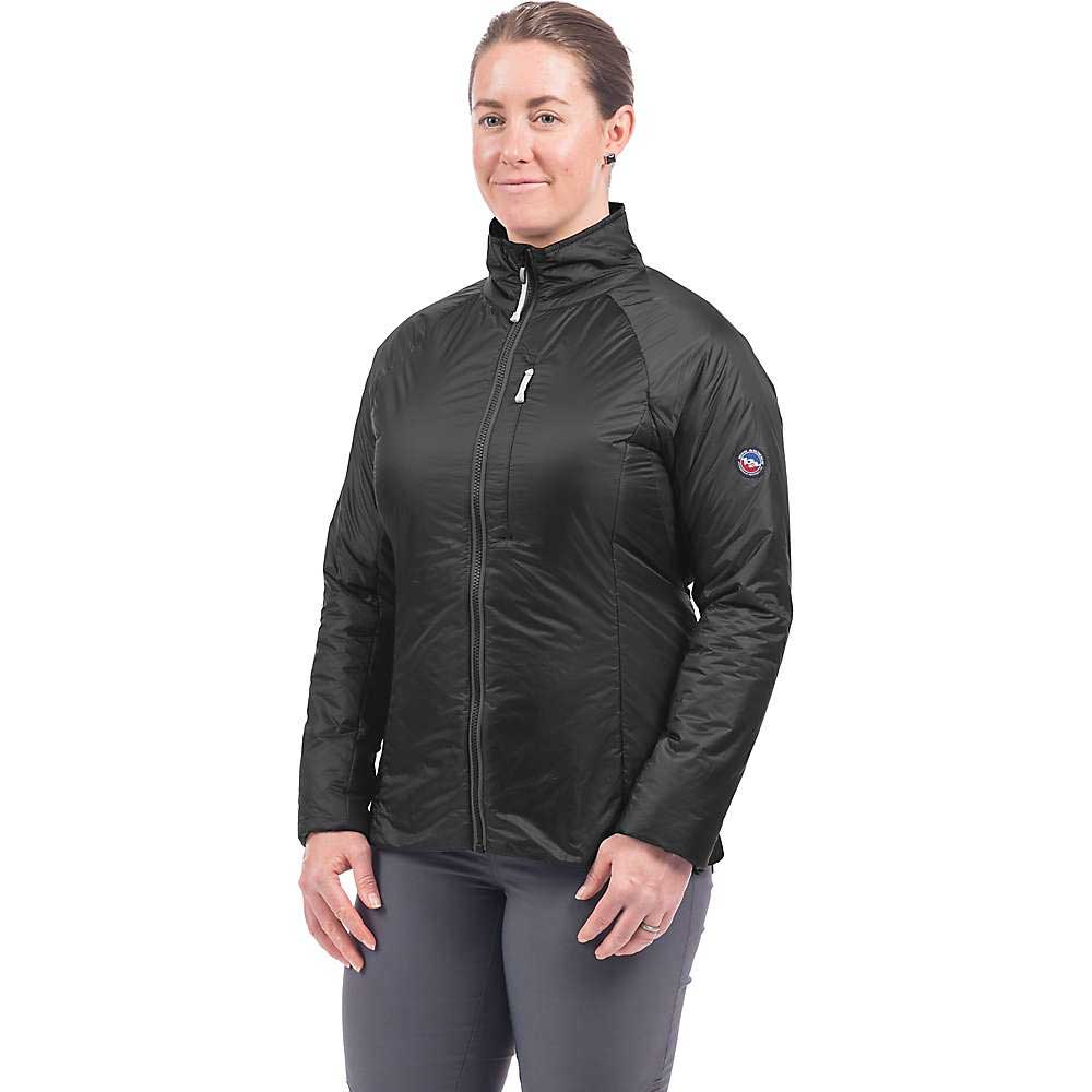 A woman faces forward wearing the Big Agnes Womens Crystal Jacket, displaying its black, zip-up style with high collar and long sleeves. The jacket’s 4-way stretch fabric offers comfort against a plain white background.