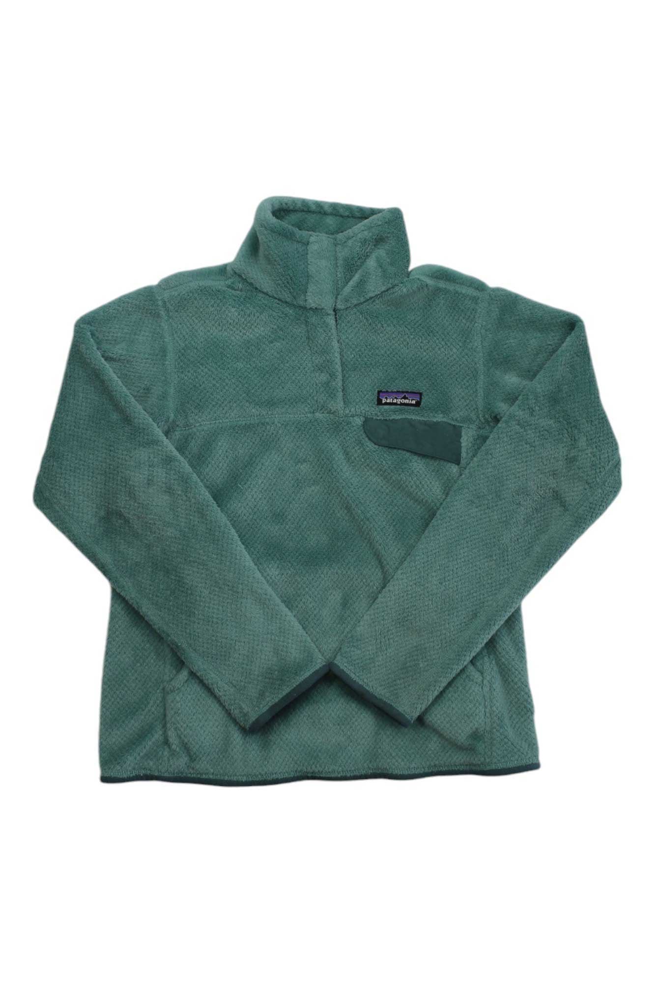 The Women’s Re-Tool Snap-T Pullover is a green, long-sleeve Polartec Thermal Pro fleece with a high collar and left chest pocket, featuring a rectangular logo patch above the pocket.