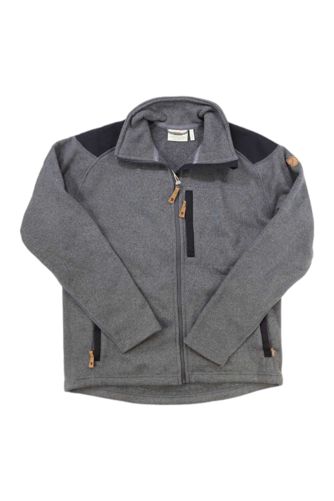 The Buck Fleece Jacket is a gray men’s fleece with black shoulder patches, a high collar, and brown zipper pulls, shown on a white background.