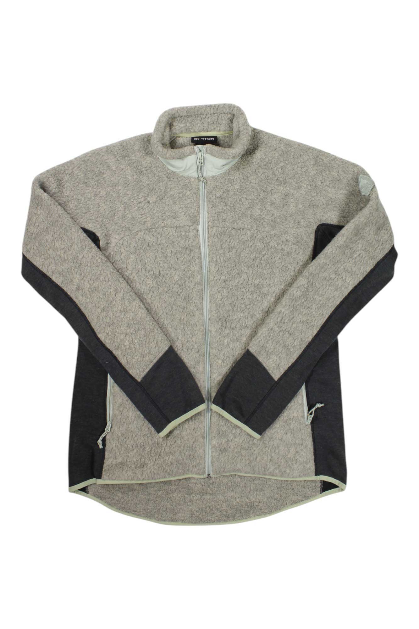 The Burton Womens Minturn Full Zip Jacket is light gray Polartec fleece with dark gray lower sleeves and sides, a high collar, and two zippered pockets.