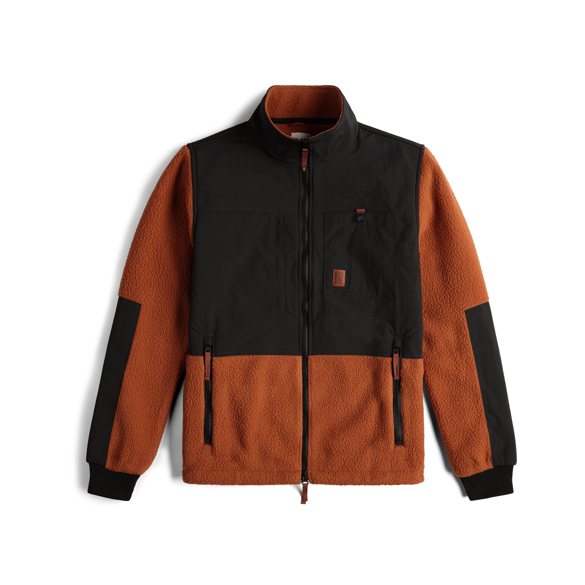 The Men's Subalpine Fleece - Brick Black features rust-orange sleeves and body, black chest and shoulders, recycled fleece, zippered side pockets, black cuffs, a high collar, and a full front zipper for modern style.