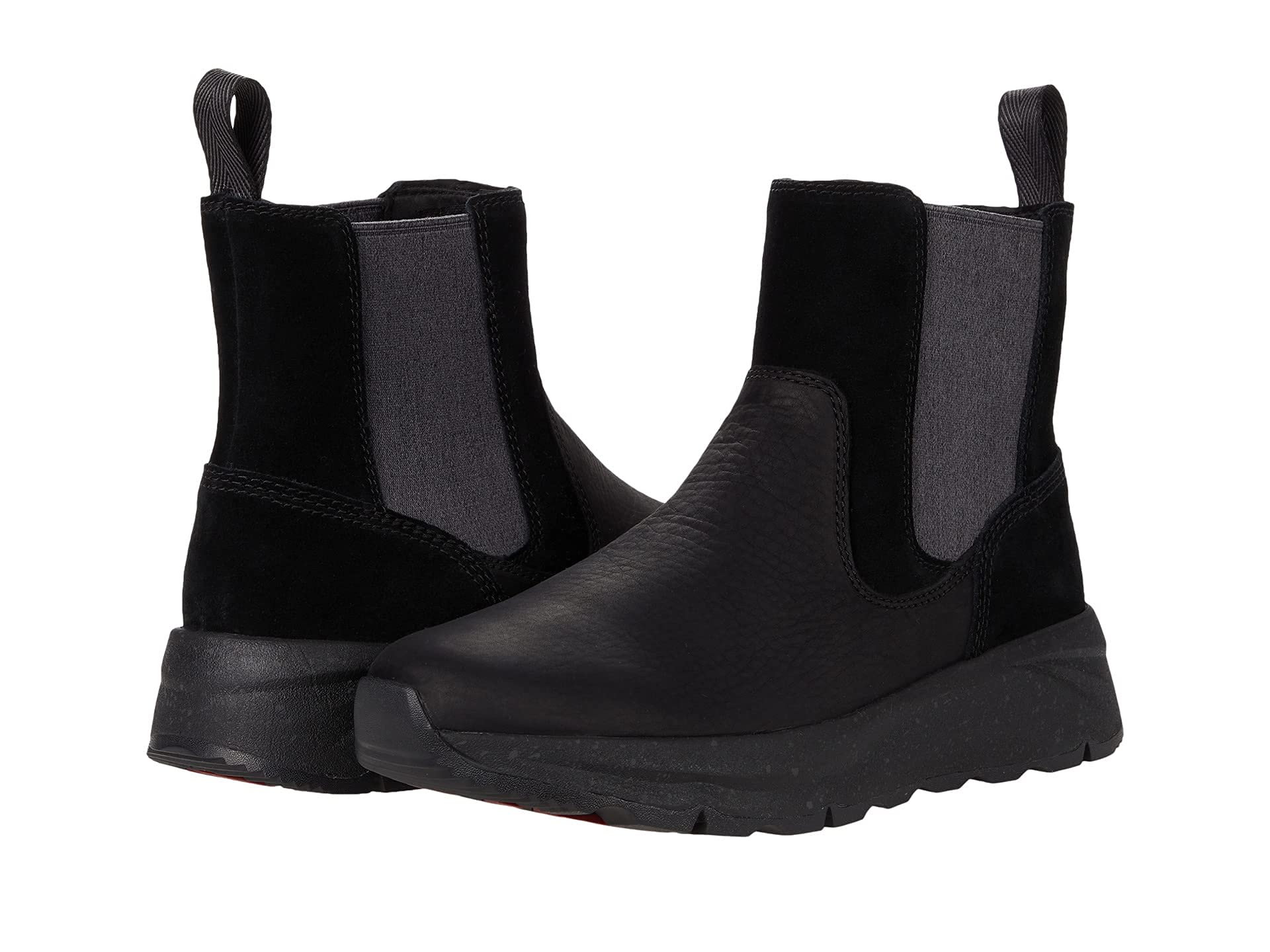 The Kodiak Takla Chelsea Boot features black leather and suede, elastic side panels, back pull tabs, and a chunky textured sole—ideal for those seeking comfort and style in a Chelsea boot.