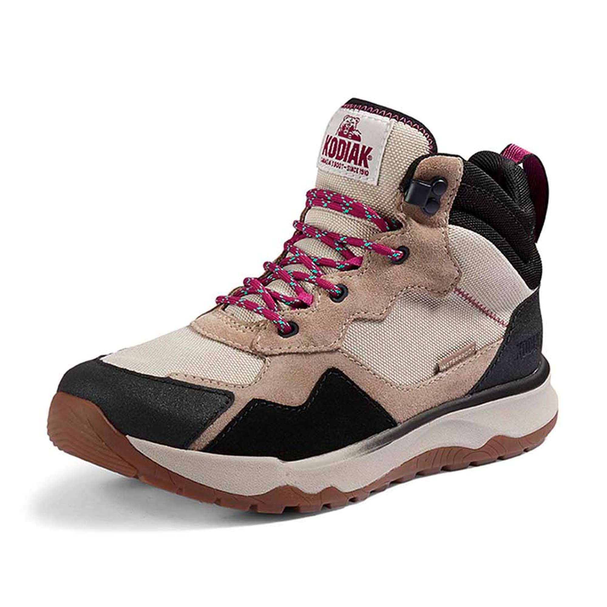 The Kodiak Women's Kenosee Waterproof Hiking Boot in Sandstone features beige, black, and tan colors, pink and gray laces, a brown tread, and Kodiak branding on the tongue, displayed against a white background.