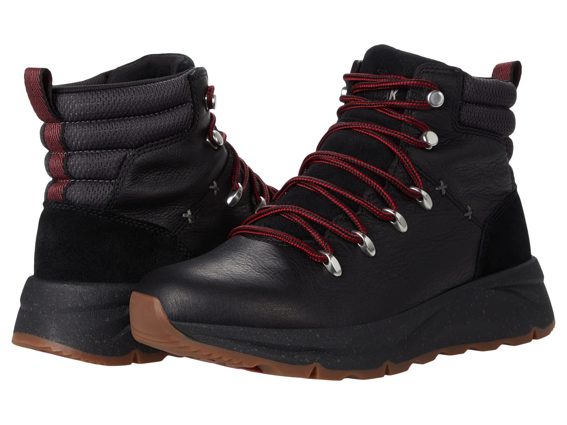 The Kodiak Kindersley Alpine Boots - Black feature red and black laces, metal eyelets, padded ankles, and brown rubber soles—rugged winter boots displayed against a white background.