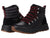 A pair of Kodiak Kindersley Alpine Boots in black with red laces, metal eyelets, and brown rubber soles. One boot stands upright showing the side; the other tilts back to reveal the padded ankle collar for alpine hiking.