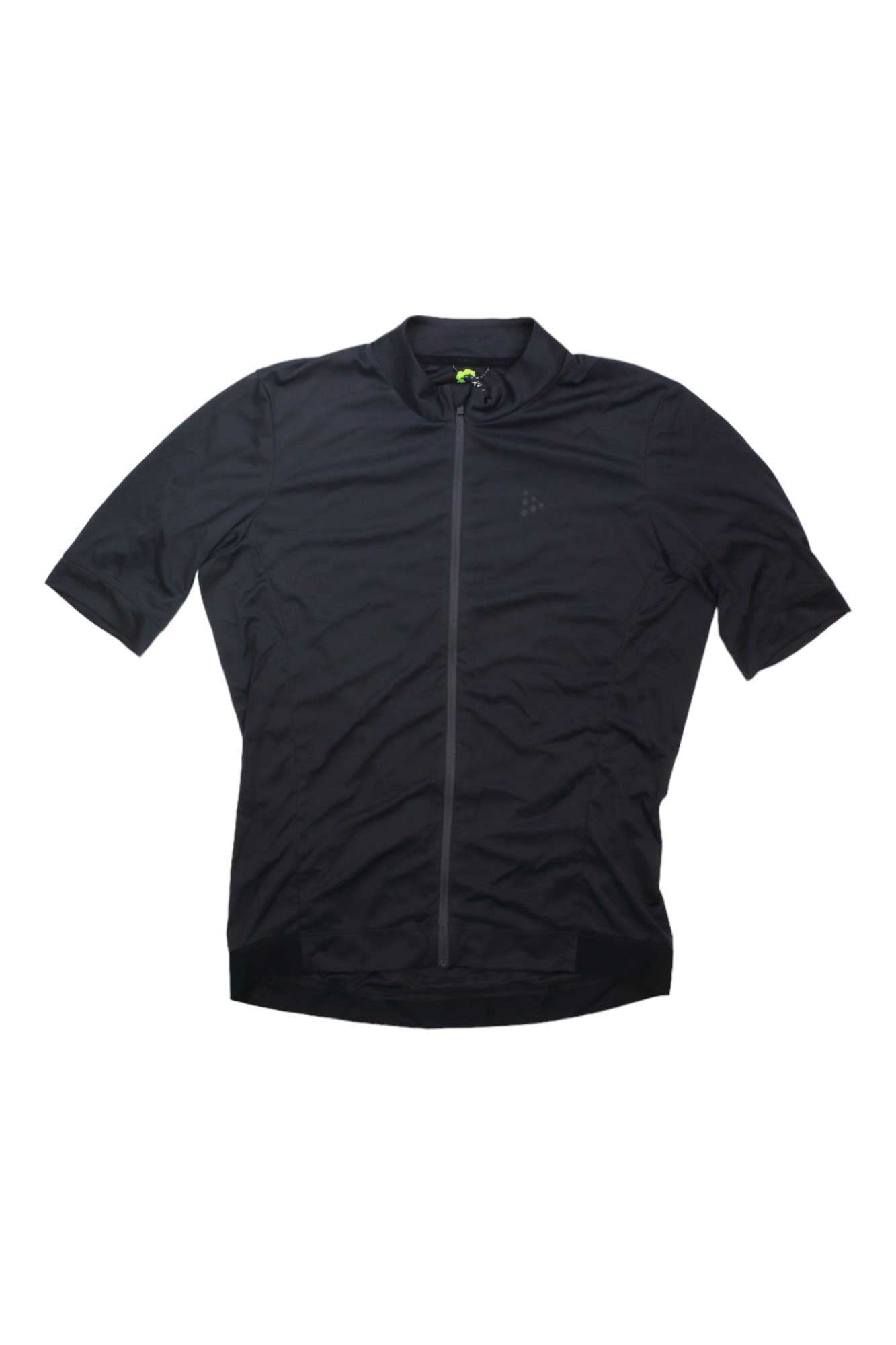 The Craft Sportswear Mens Essence Jersey is a short-sleeved, black cycling jersey for men with a full front zipper and moisture-wicking fabric, shown laid flat on a white background.
