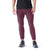 A person wearing a black T-shirt, Smartwool Men's Active Fleece Tech Pant in maroon, and black athletic shoes stands against a white background. The image captures the person from shoulders to feet.