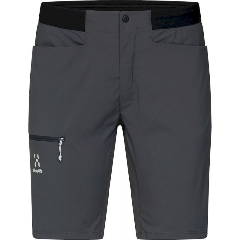 The Haglofs Womens L.I.M Rugged Short features a dark gray design with a black waistband, two front pockets, a zippered right leg pocket with the Haglöfs logo, and a front button closure—perfect for outdoor adventures.