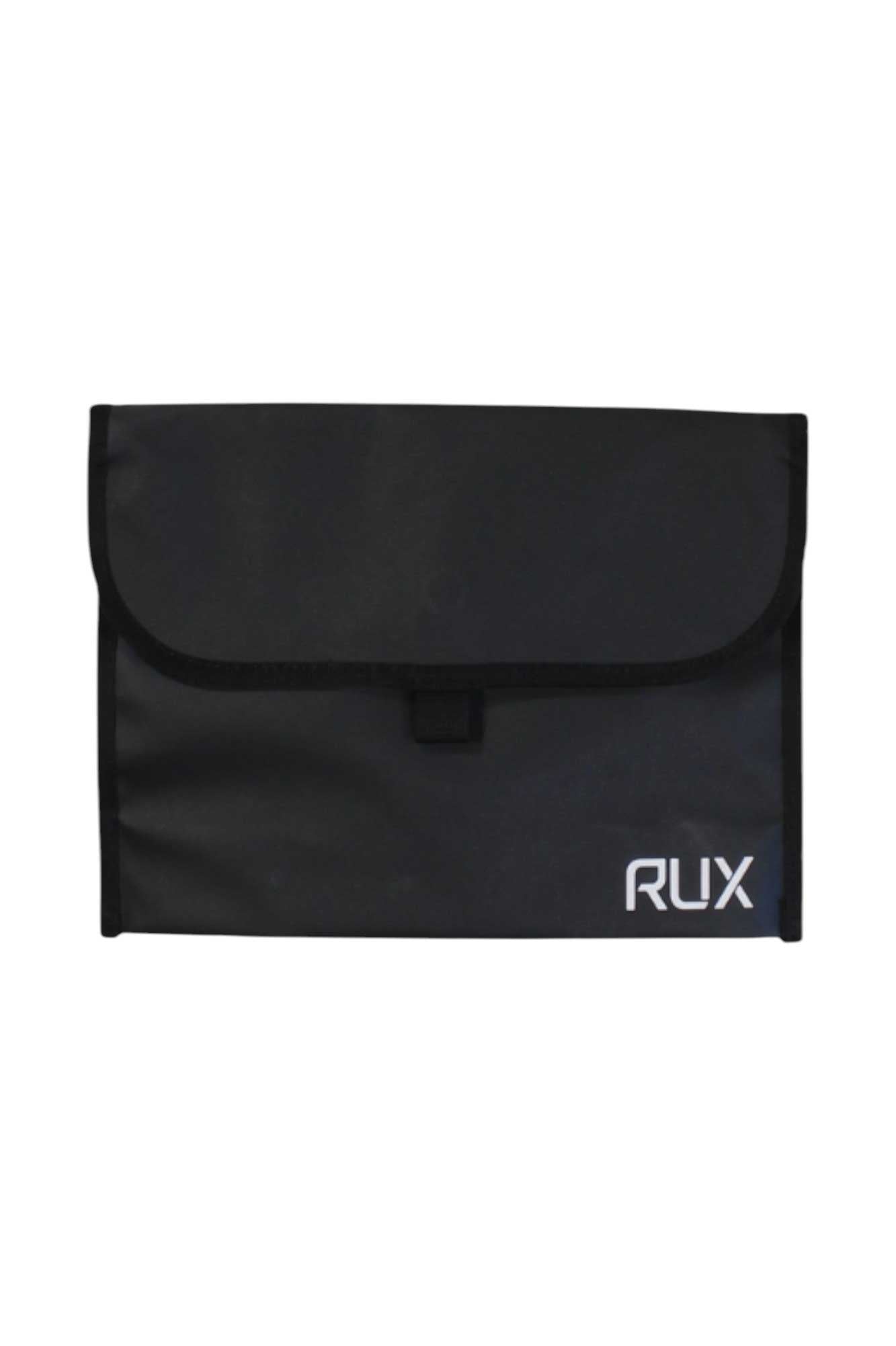 The RUX Pocket is a black rectangular travel pouch with a flap closure and the white RUX logo in the bottom right corner—ideal for organizing your essentials on the go.