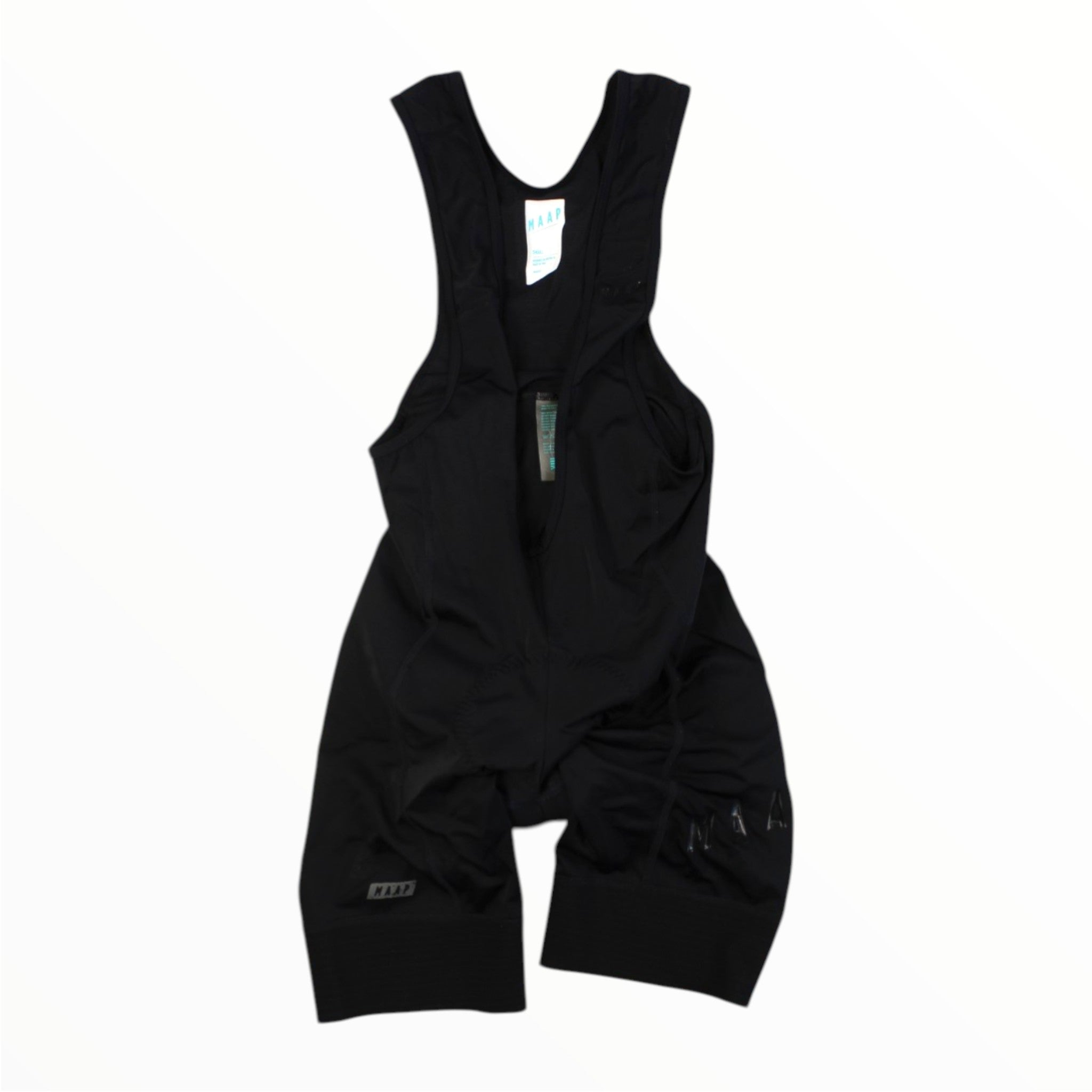 Maap Mens Training Bib cycling bib shorts are laid flat on a white background, featuring shoulder straps and a small tag near the neckline. Made from moisture-wicking Italian fabric for superior comfort.