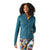 A woman with curly hair smiles while wearing a teal Smartwool Womens Smartloft Jacket with Merino wool insulation and colorful patterned leggings against a white background.