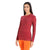 A woman models the Icebreaker Women's 200 Oasis Ski Tracks LS Crewe, a cozy merino wool long sleeve shirt in red and navy stripes with an orange waistband—ideal for après-ski style.