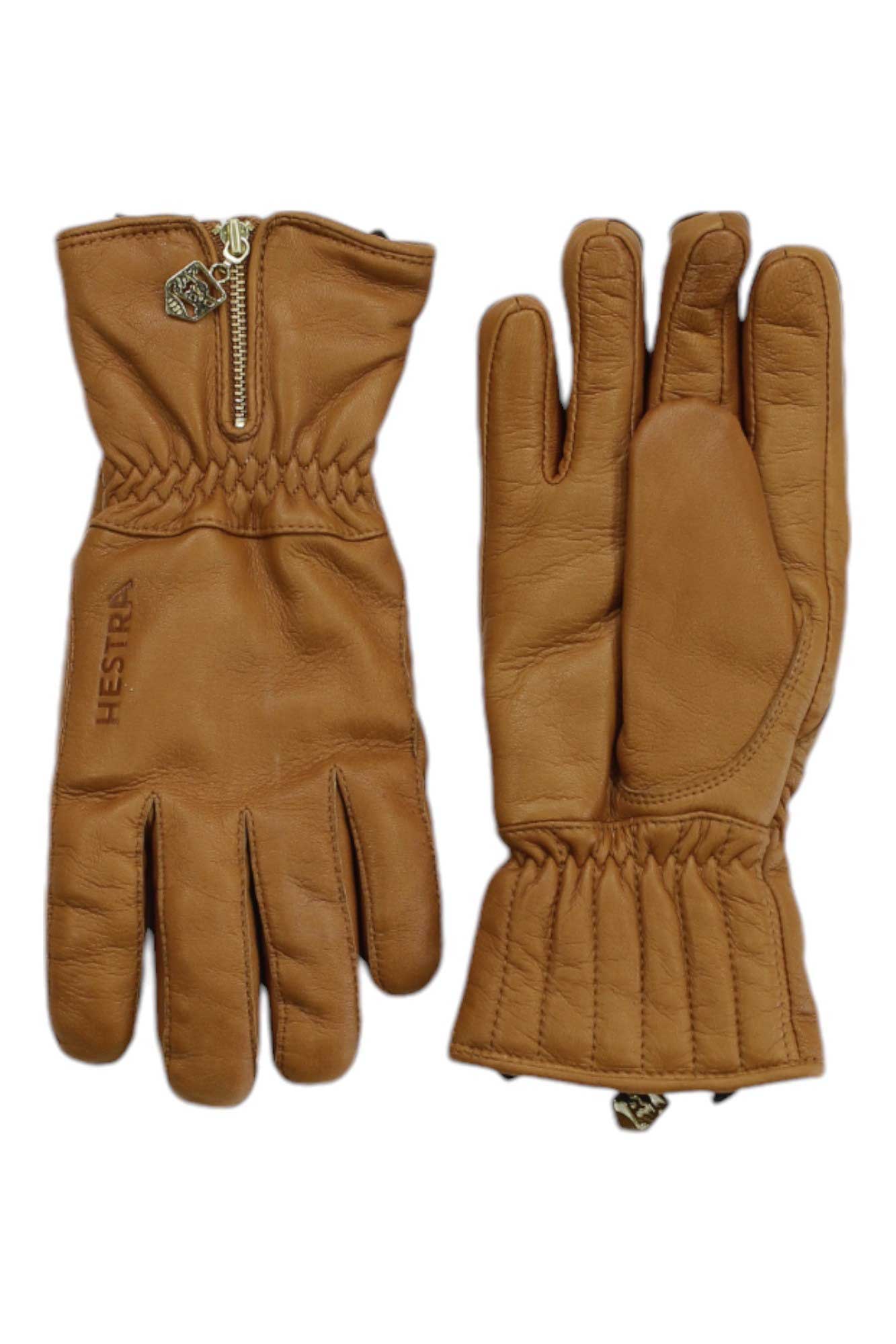 A pair of brown Hestra Leather Swisswool Classic Gloves with elastic wrists and gold zippers—one palm side, one back with HESTRA branding—are displayed on a white background.