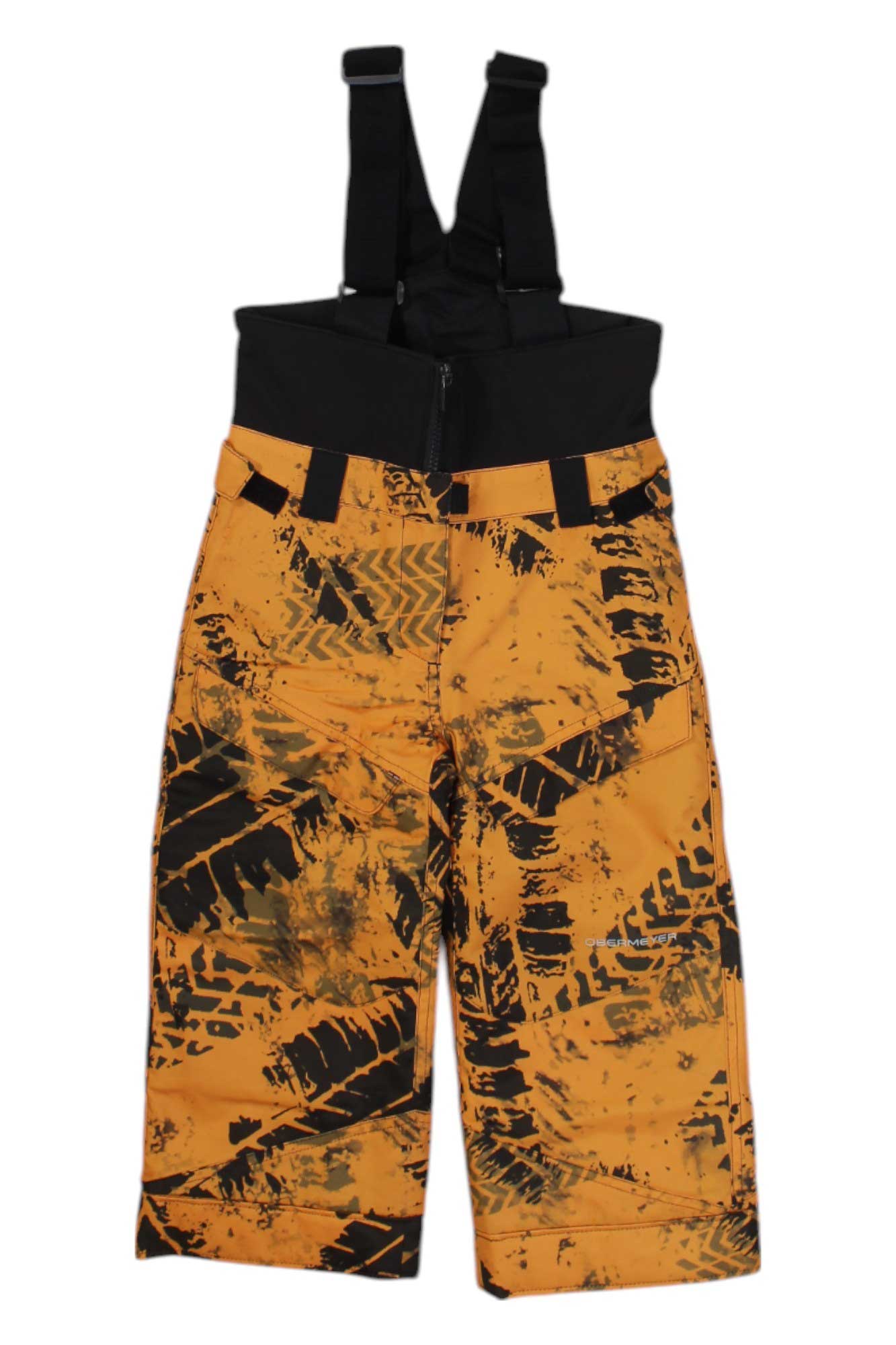 The Obermeyer Boys Warp Pant features yellow and black insulated ski pants with an abstract tire track design, adjustable black suspenders at the waist, and waterproof fabric, shown against a white background.